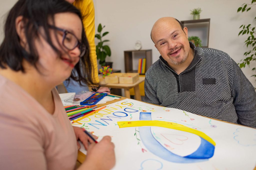 Support worker helping a client plan for moving into a new home as part of life transition assistance.