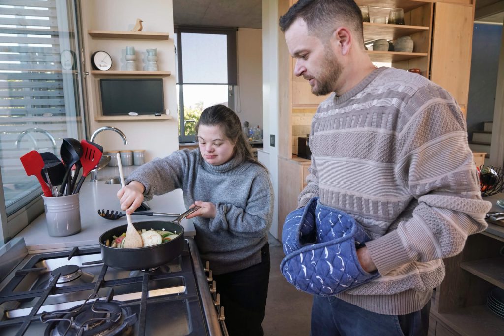 Support worker helping with household cleaning and chores in a participant’s home.
